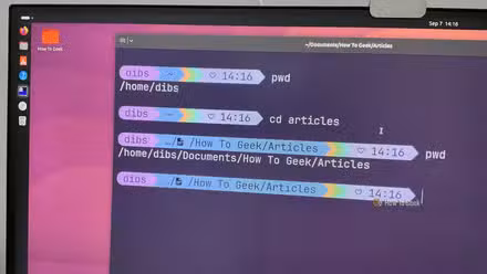 A computer monitor with Ubuntu running and the terminal showing cd and pwd command.