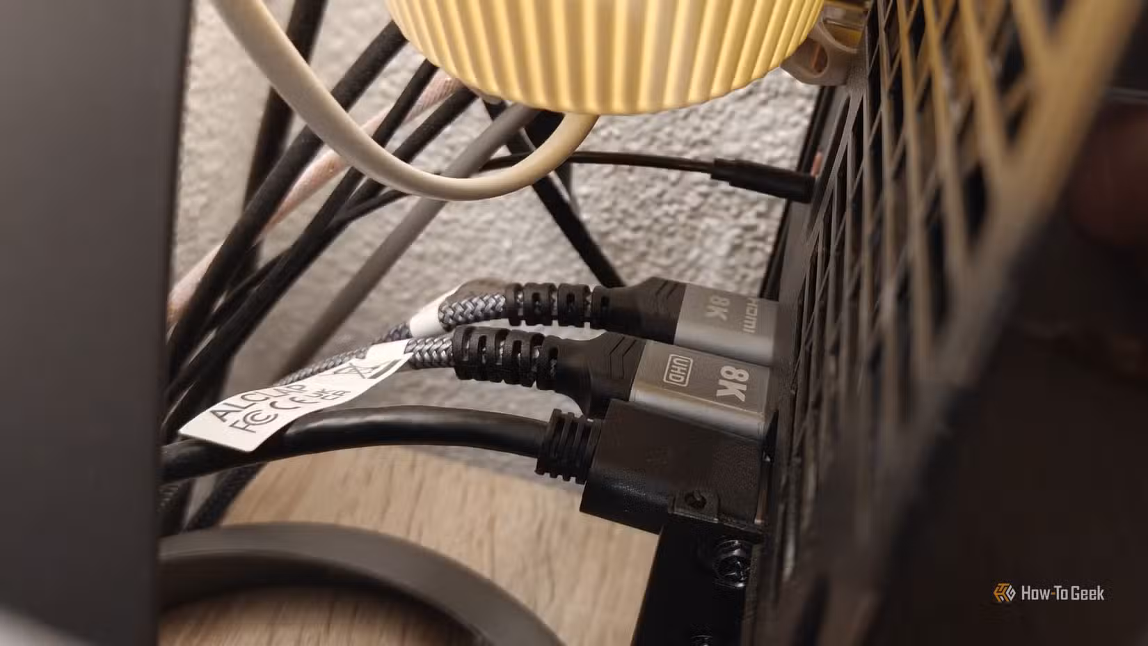A cheap HDMI and DisplayPort cable plugged into the back of a PC, showing 8k as its display.
