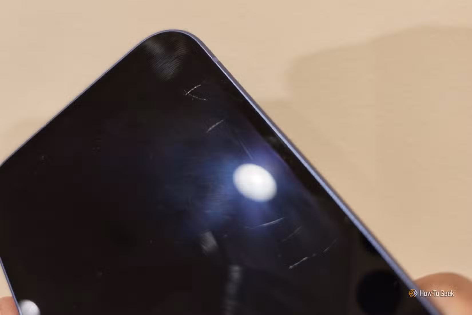 Scratches on the screen of a Google Pixel 10a.