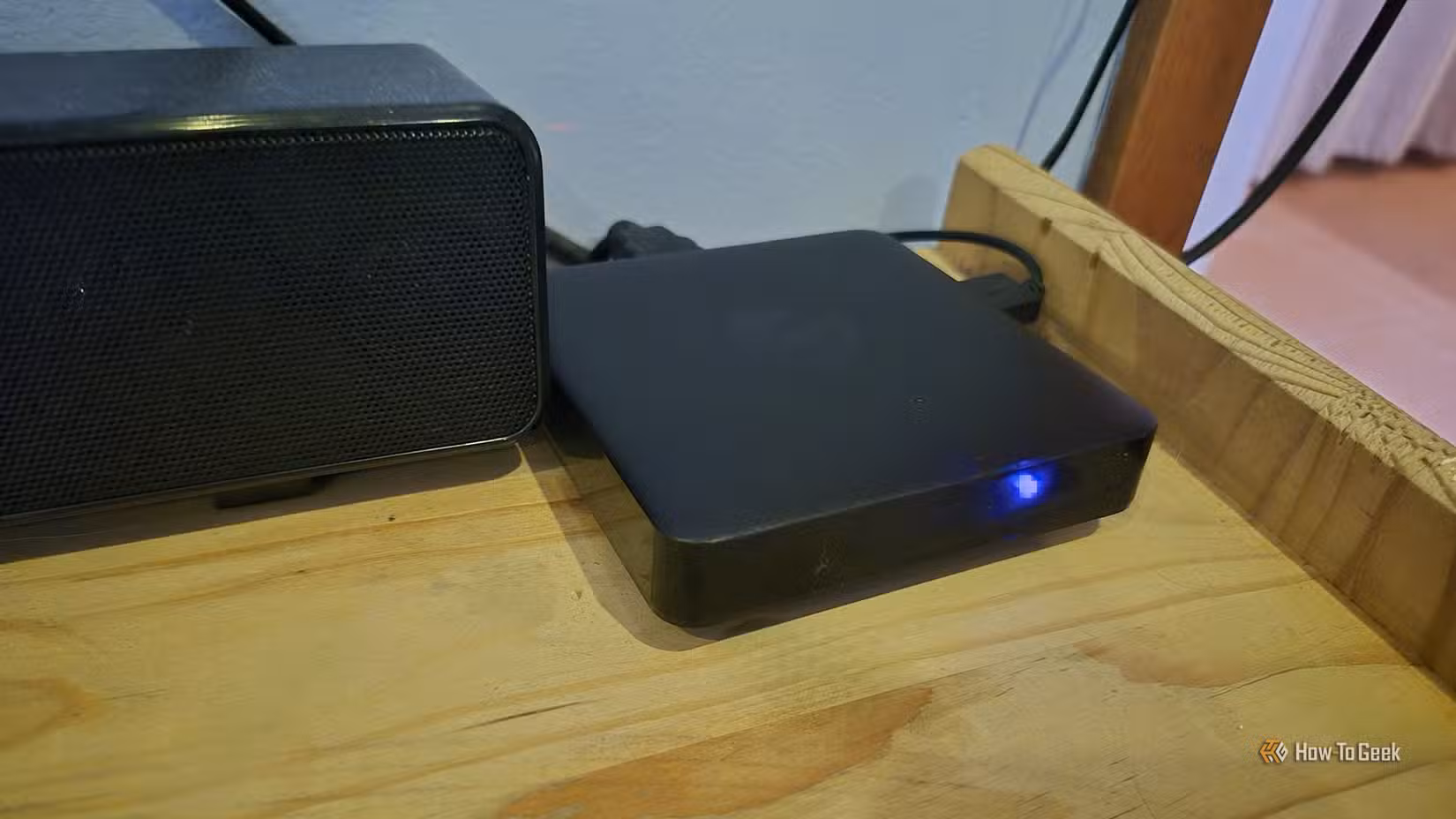 An Ematic dv8235 Android TV box on a bookshelf