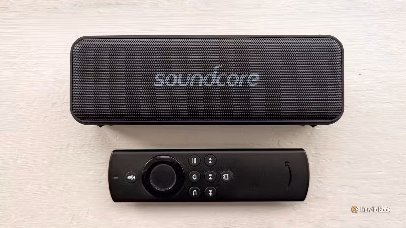 A Bluetooth speaker and a Fire Stick remote.