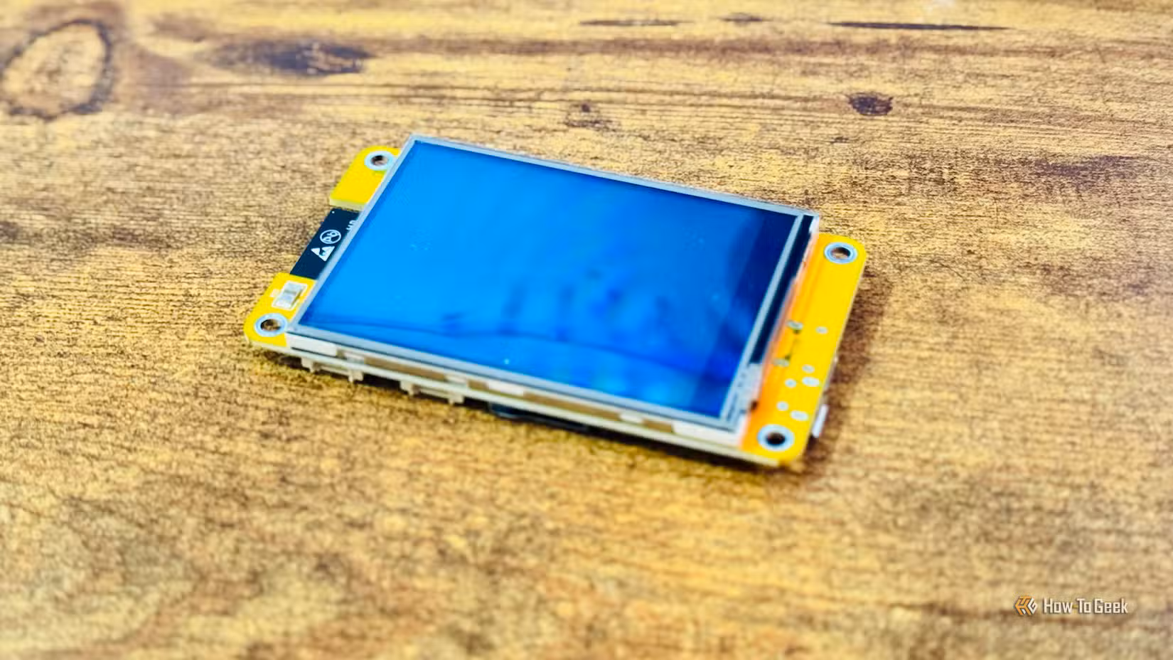 A Cheap Yellow Display lying on a desk.