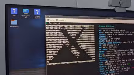 A desktop PC with MX Linux running and Fastfetch showing the MX Logo.