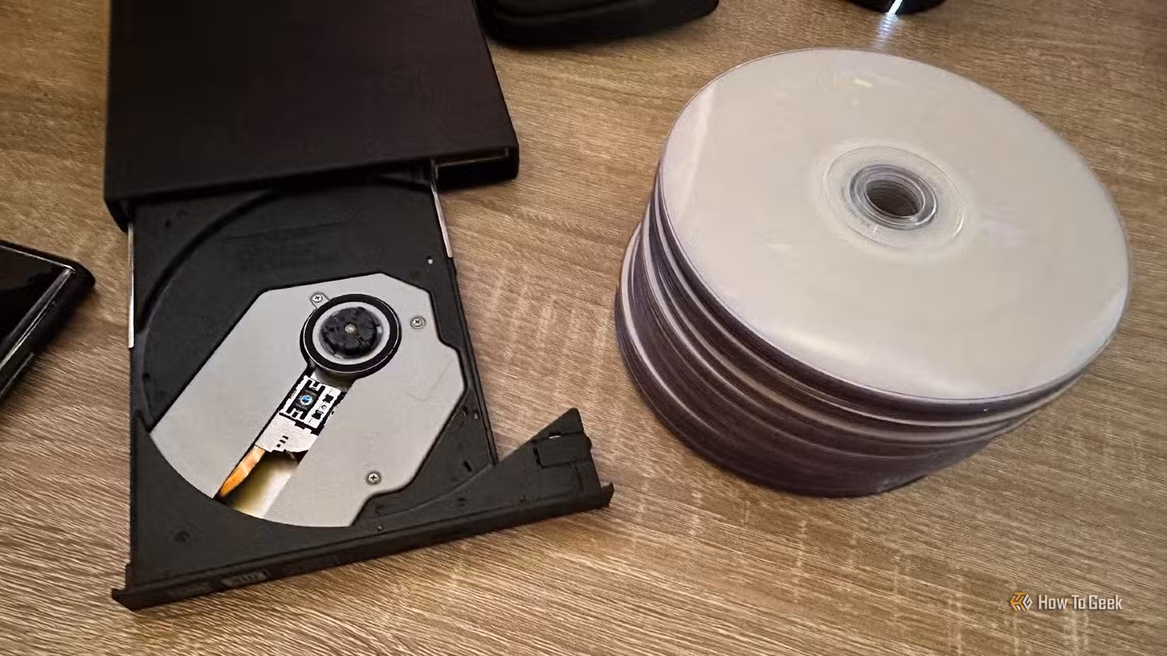A DVD burner with pile of blank discs