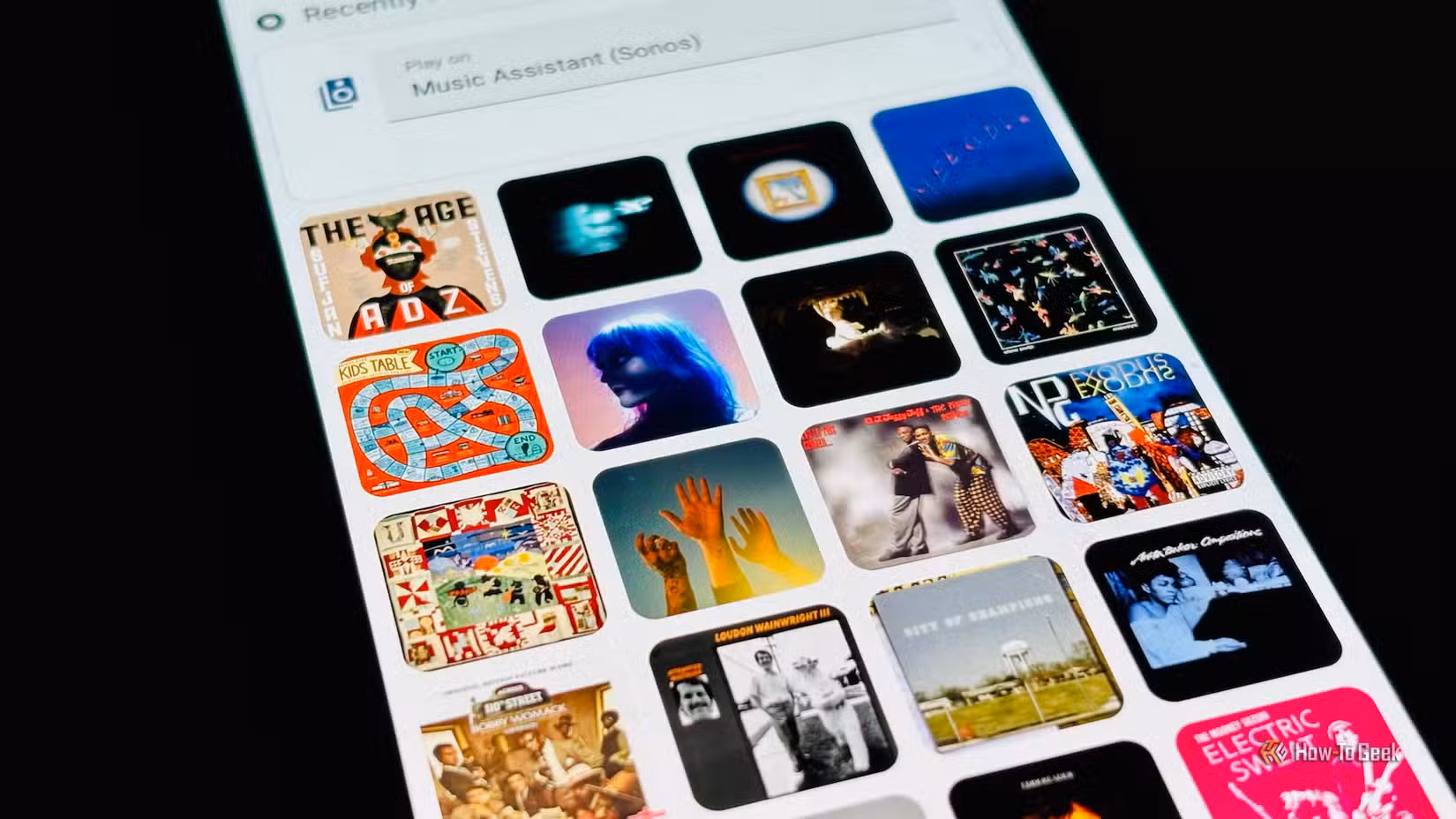 A Home Assistant dashboard showing album covers from Music Assistant.