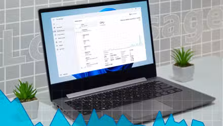 A laptop with the Windows 11 Task Manager open, showing a graph indicating low resource usage.