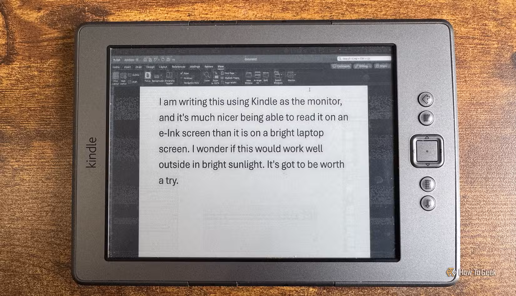A Mac desktop with the Word app being mirrored to a Kindle 4.