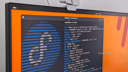A PC monitor with a Linux terminal open showing the FastFetch output for Fedora.