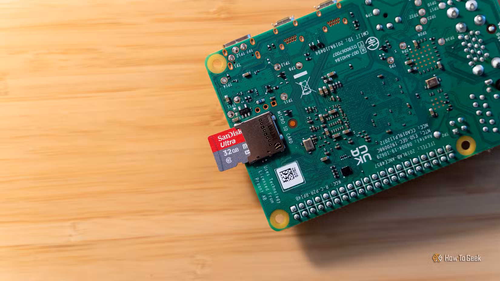 A 32GB microSD card halfway inserted into a Raspberry Pi 4b.
