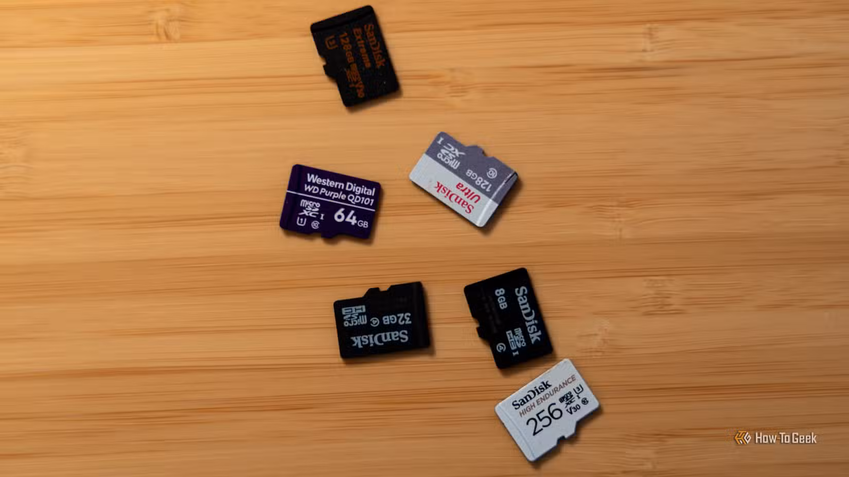 Several microSD cards sitting on a wooden table.