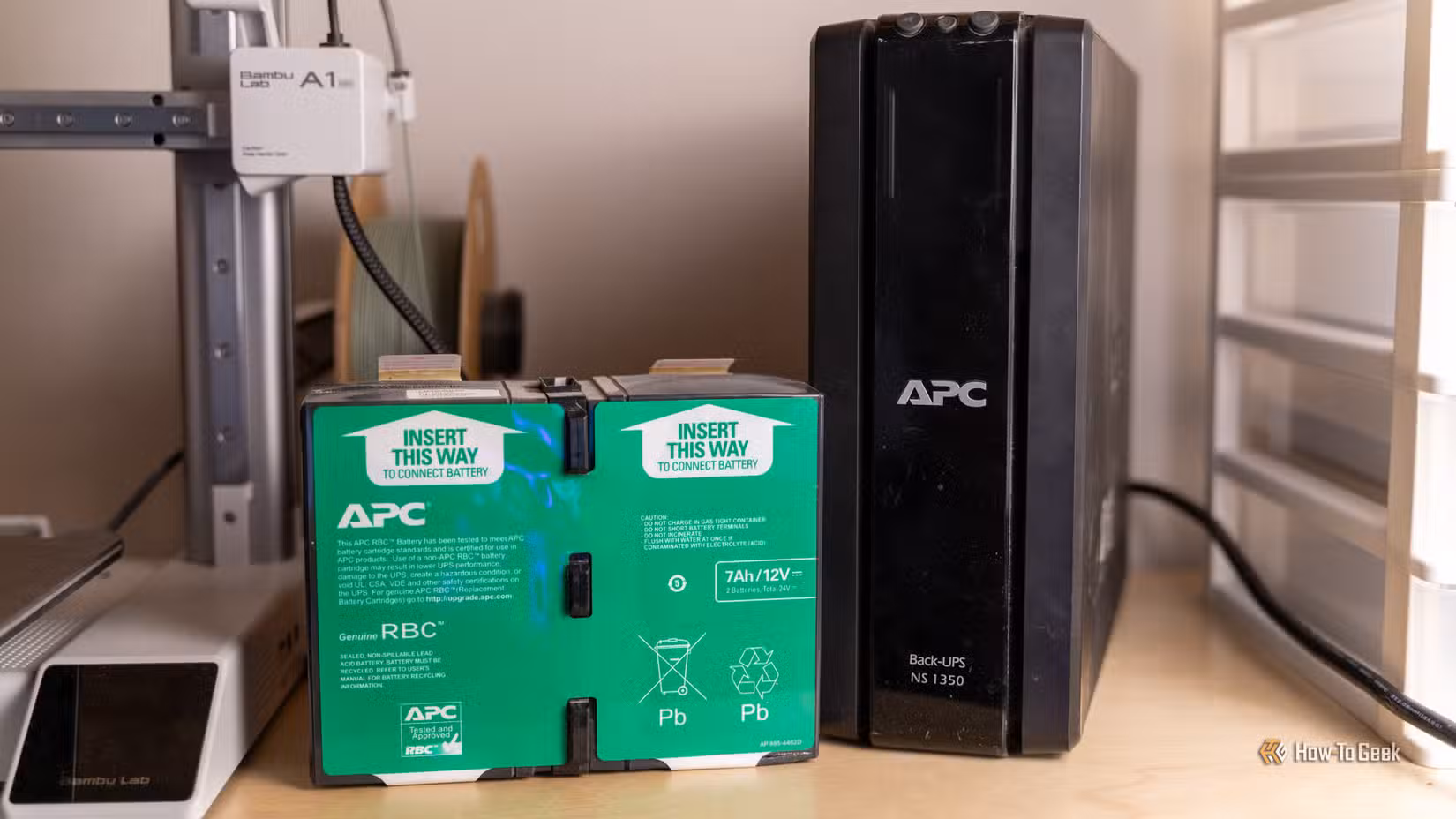 The APC BackUPS NS1350 UPS with an old battery sitting next to it.