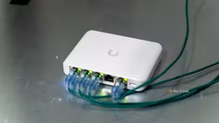The Unifi Flex Mini 2.5G Ethernet switch with cables plugged in sitting on a server.