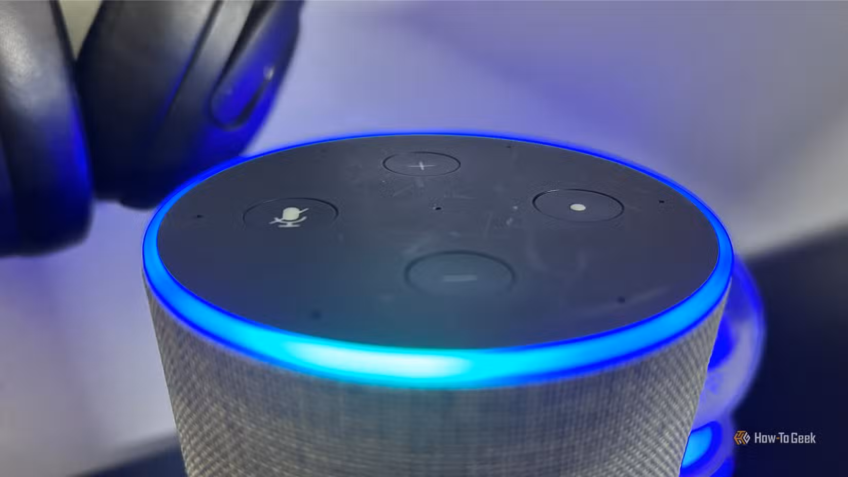 Close-up of an Amazon Echo Gen 2 with the light ring indicator lit up.