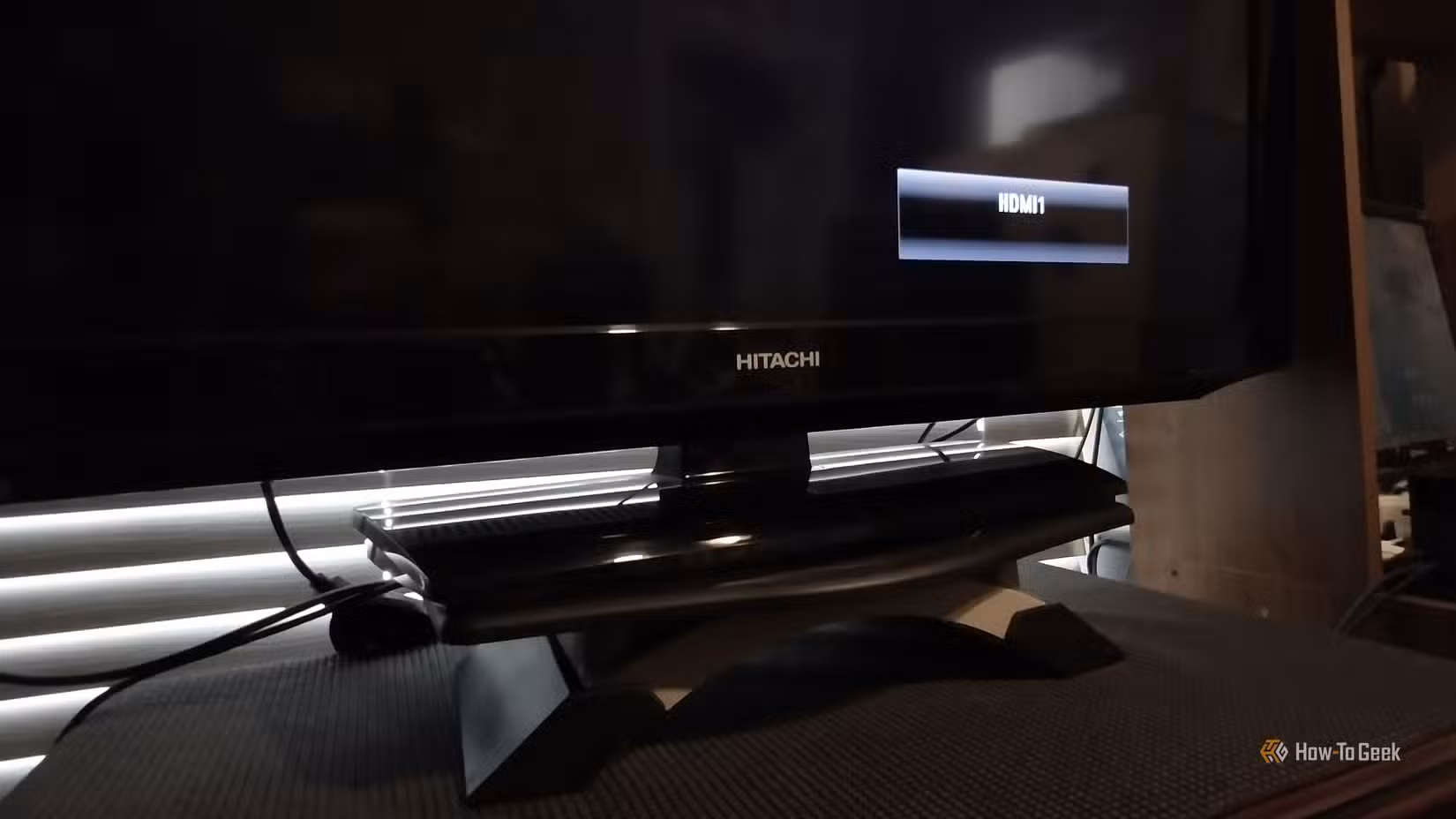 Photo of Google TV Stick showing a black screen on a Hitachi HDTV