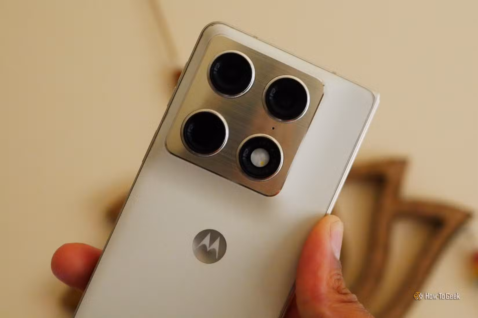 Hand holding up a Motorola Razr Fold. 