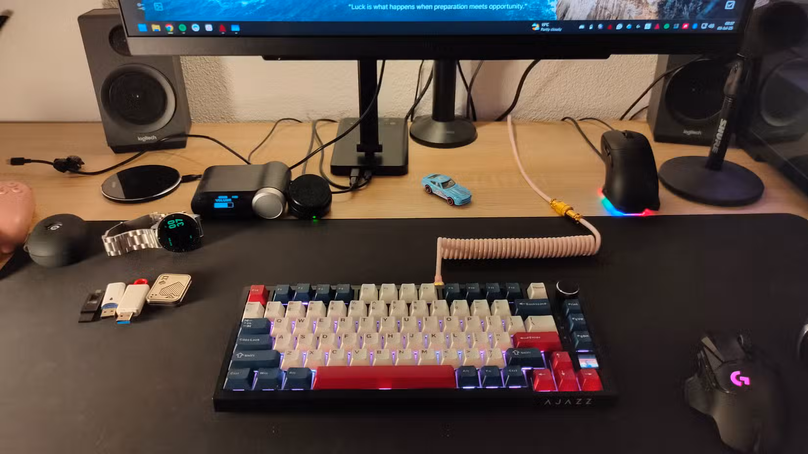 A computer desk with messy cables.