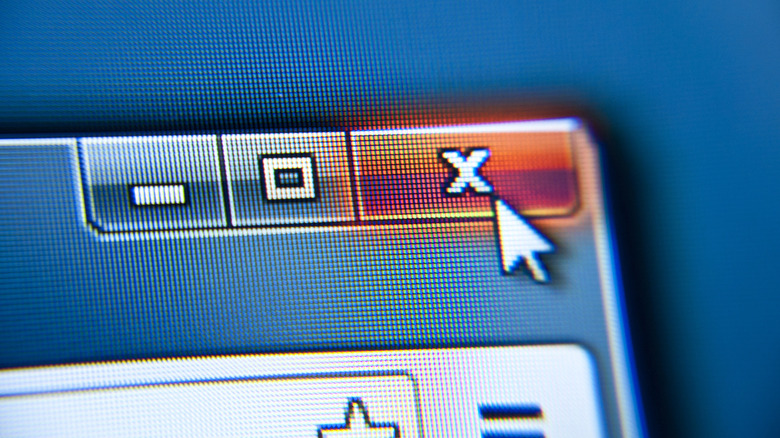 A mouse cursor clicking the X icon on an app window.