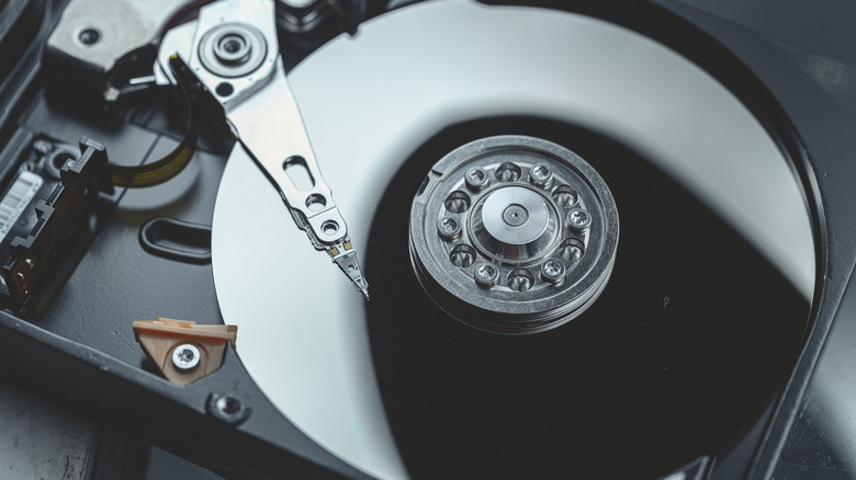 Close-up of a hard disk drive showing its platters and arm.
