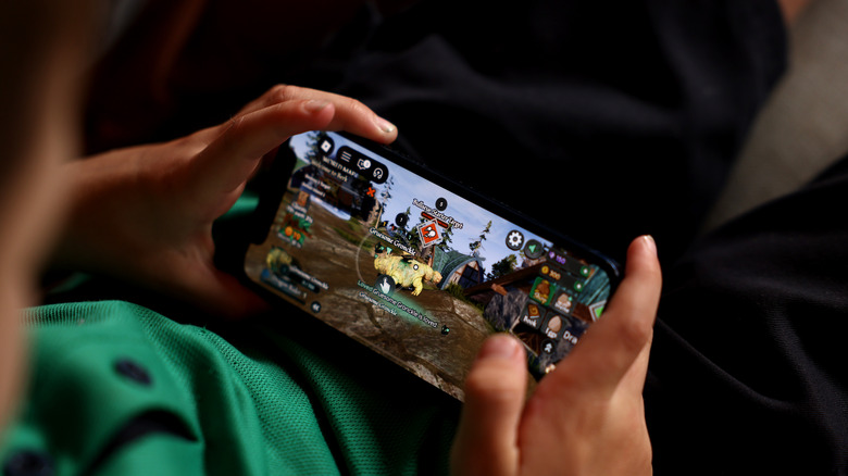A smartphone using playing Roblox on an iPhone.