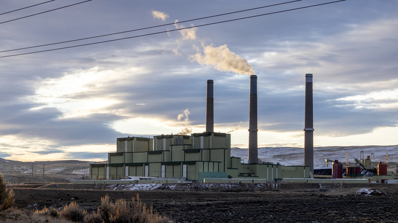 Photo of Craig Generation Station in Craig, CO. A trio of smokestacks above a power plant with a cloudy sky behind them..