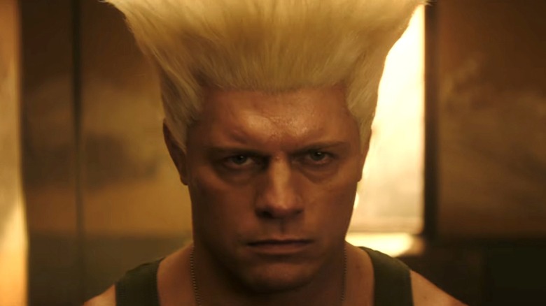 A man with a stern look on his face and a oversized flattop hairstyle.