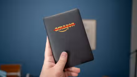 Kindle eReader with Amazon logo crossed out.