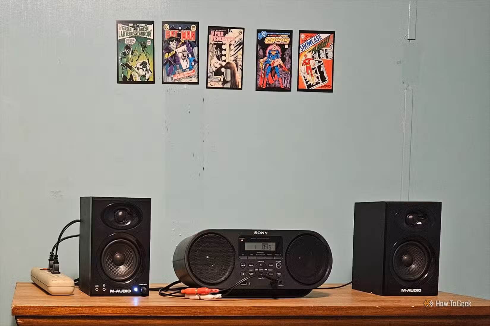 A Sony CD player sits on a table flanked by two M-Audio studio monitors.