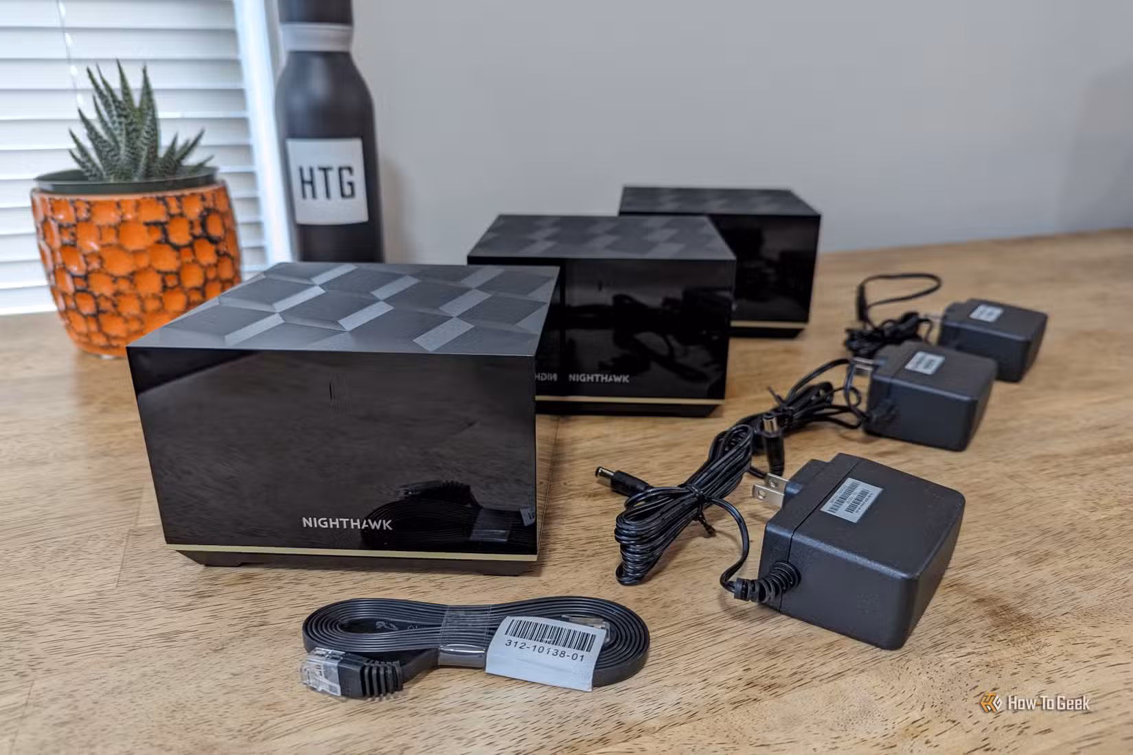 Contents of the box in the Netgear Nighthawk MK93S system arranged on a tabletop.