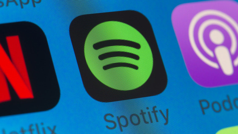 The Spotify app icon on an iPhone screen.