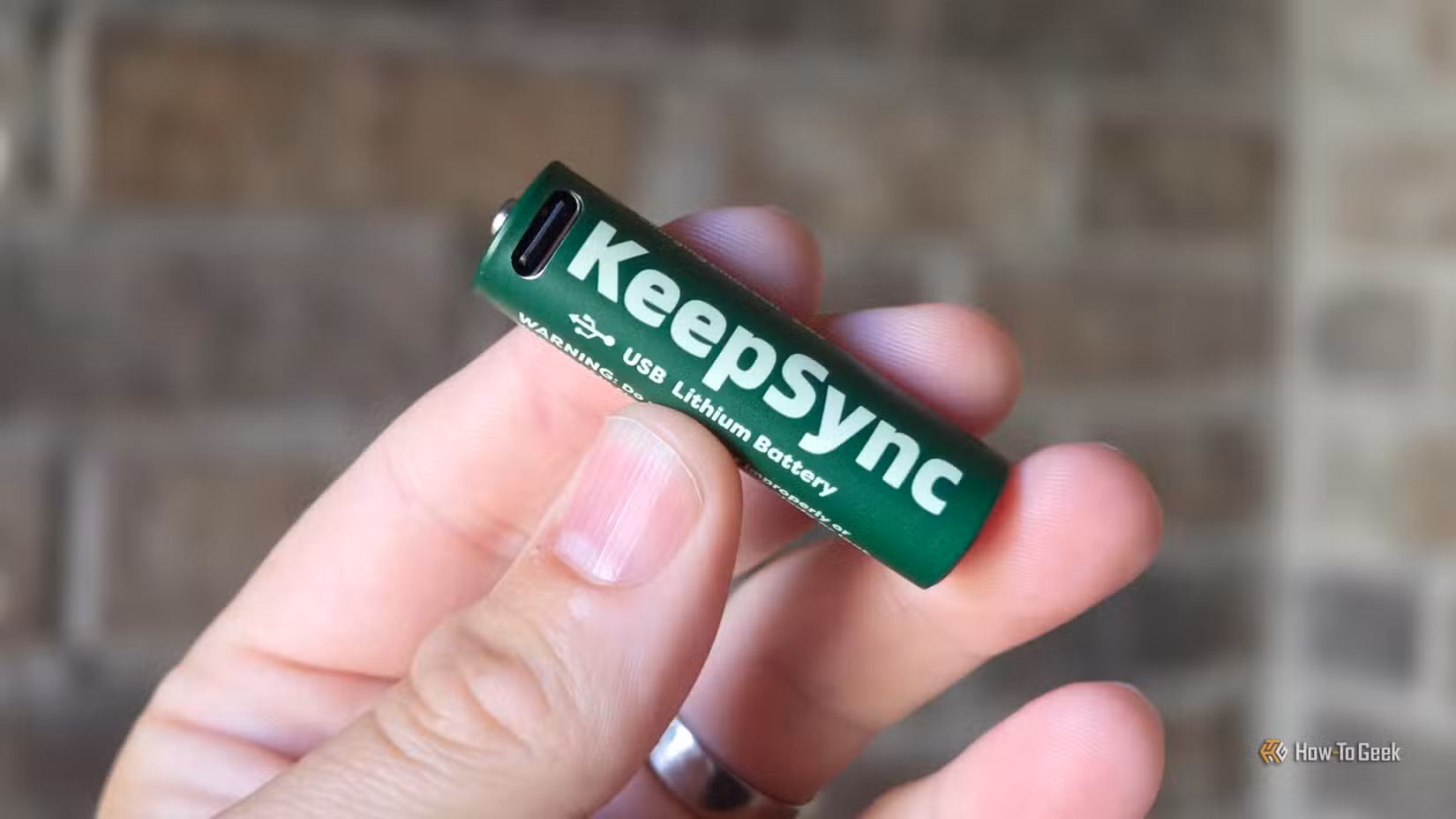 Person holding USB-C AA rechrgeable battery
