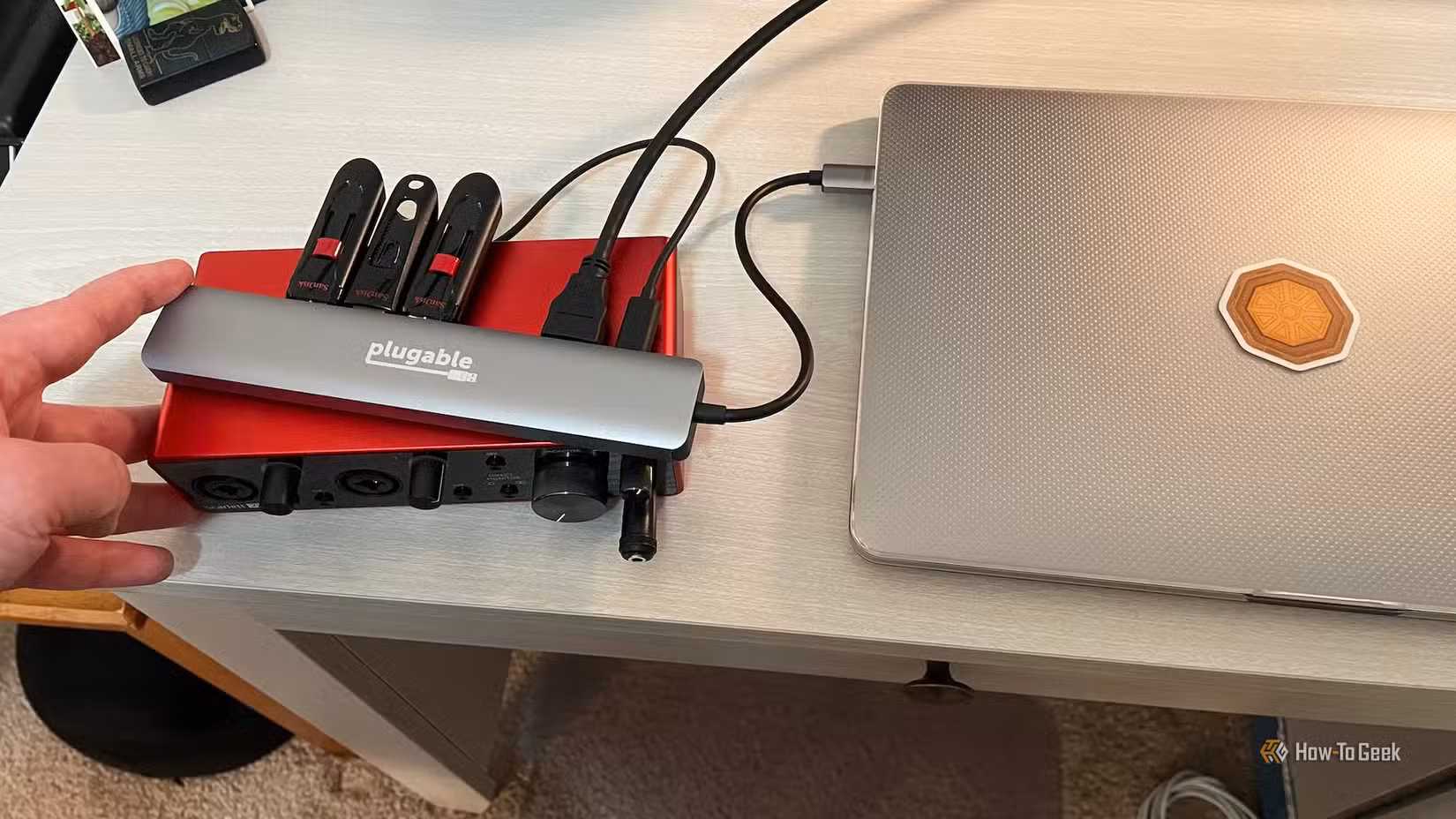 A laptop, three external flash drives, and a recording interface connected to the Plugable 9-in-1 USB-C Hub.