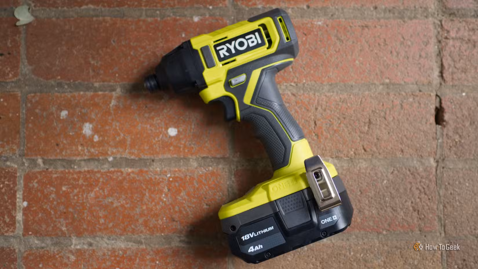 Ryobi impact driver on a brick surface.-1