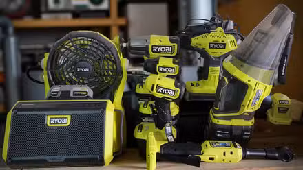 A bunch of Ryobi tools in a garage. 