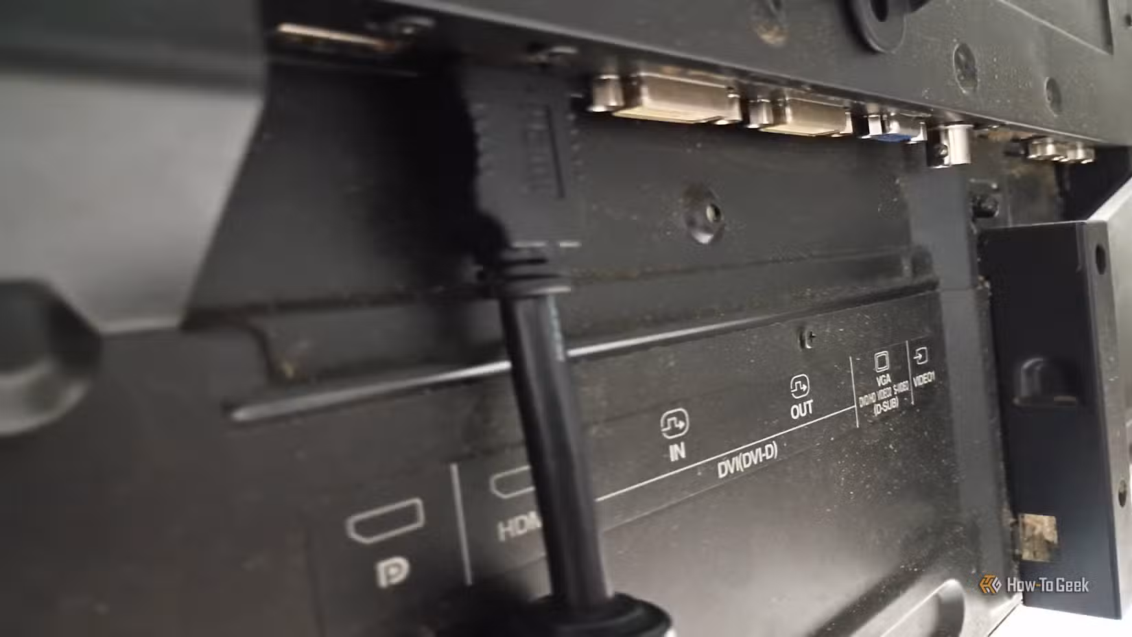The back of a modern TV showing an HDMI cable, a DVI port, a VGA port, and a coaxial port.