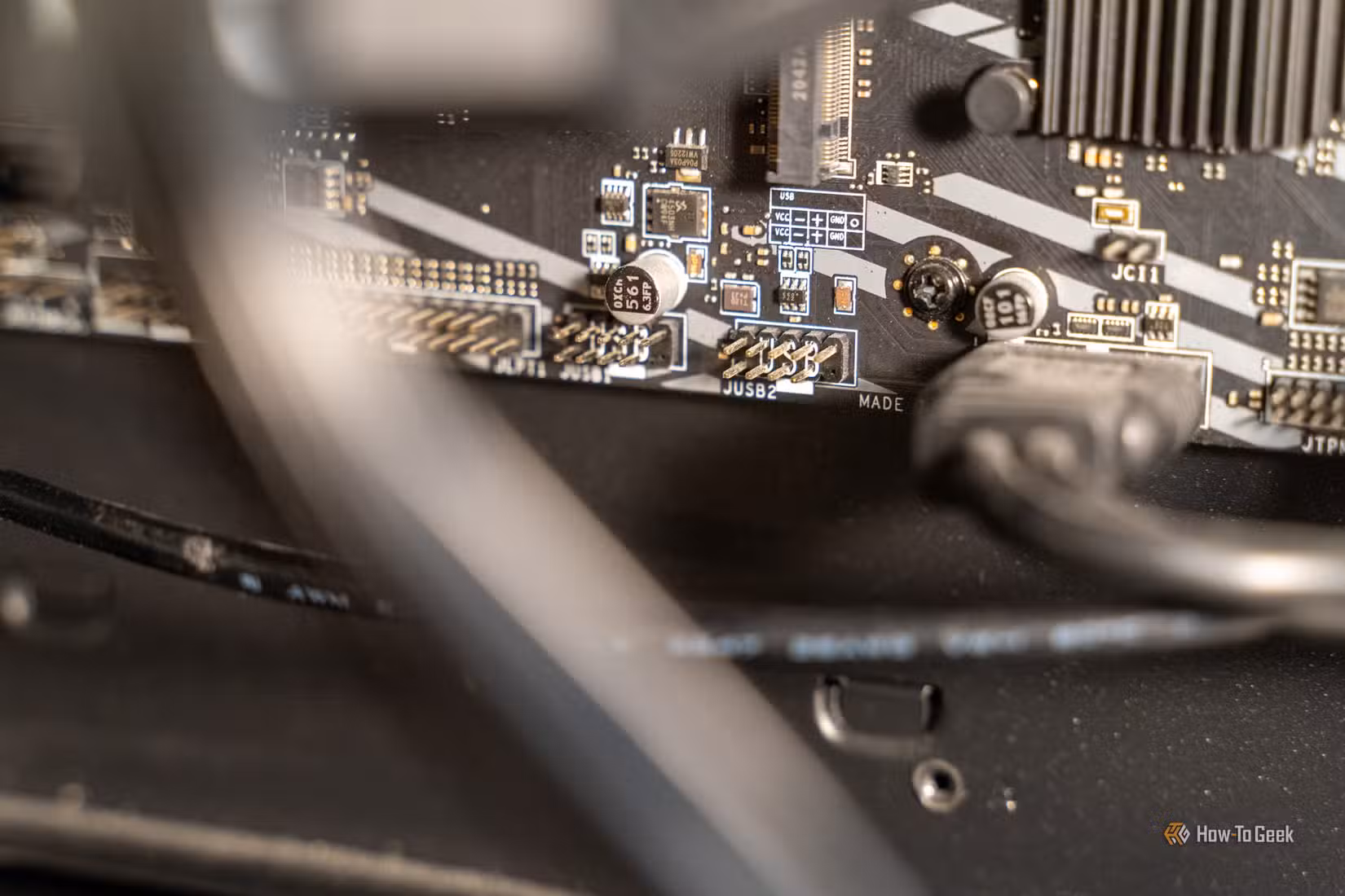 Unused motherboard USB 2.0 headers with JUSB2 label and pinout diagram viewed at an angle.