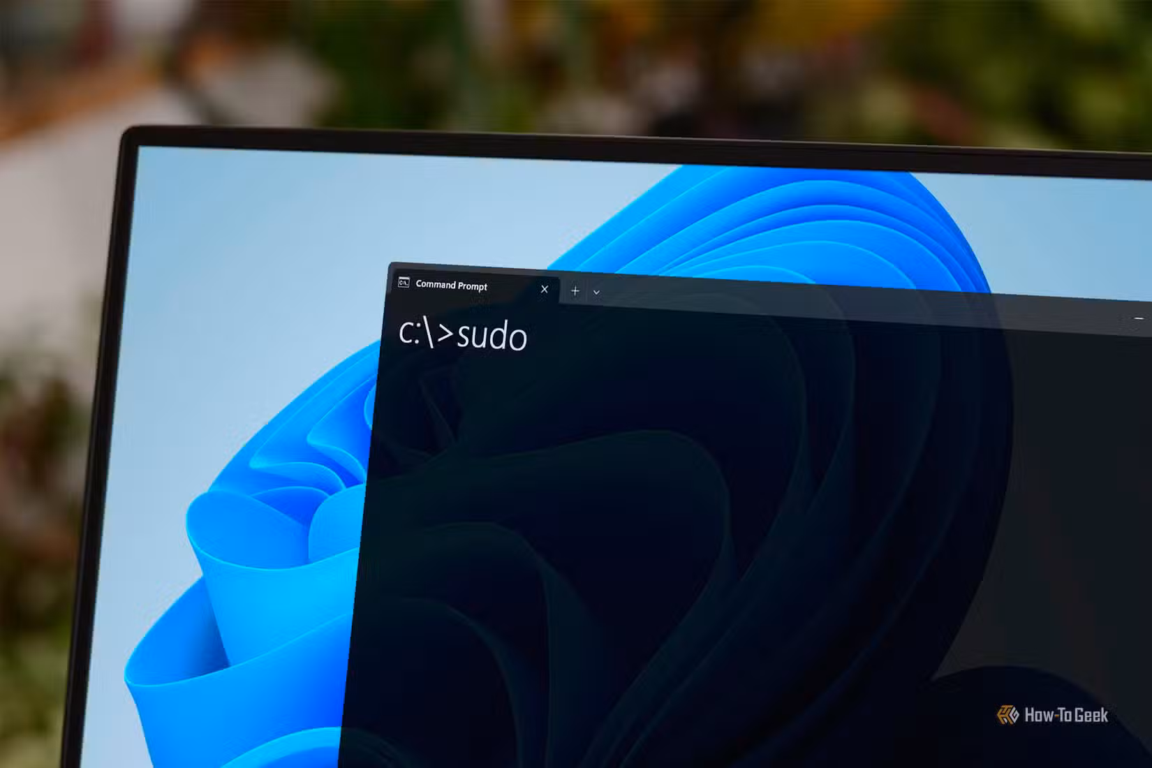 Windows laptop with the Command Prompt open displaying a 'sudo' command